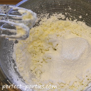 Adding sugar to the Buttercream Icing