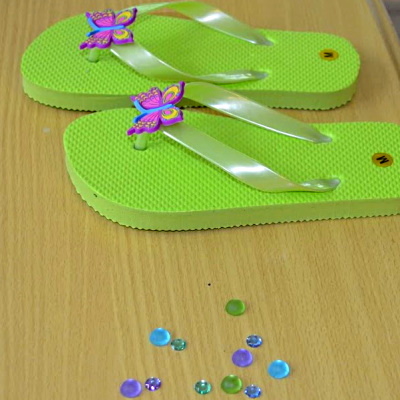 Line up your decorations to glue on your flip flops to plan it out.